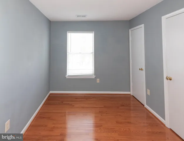 an empty room with wooden floor