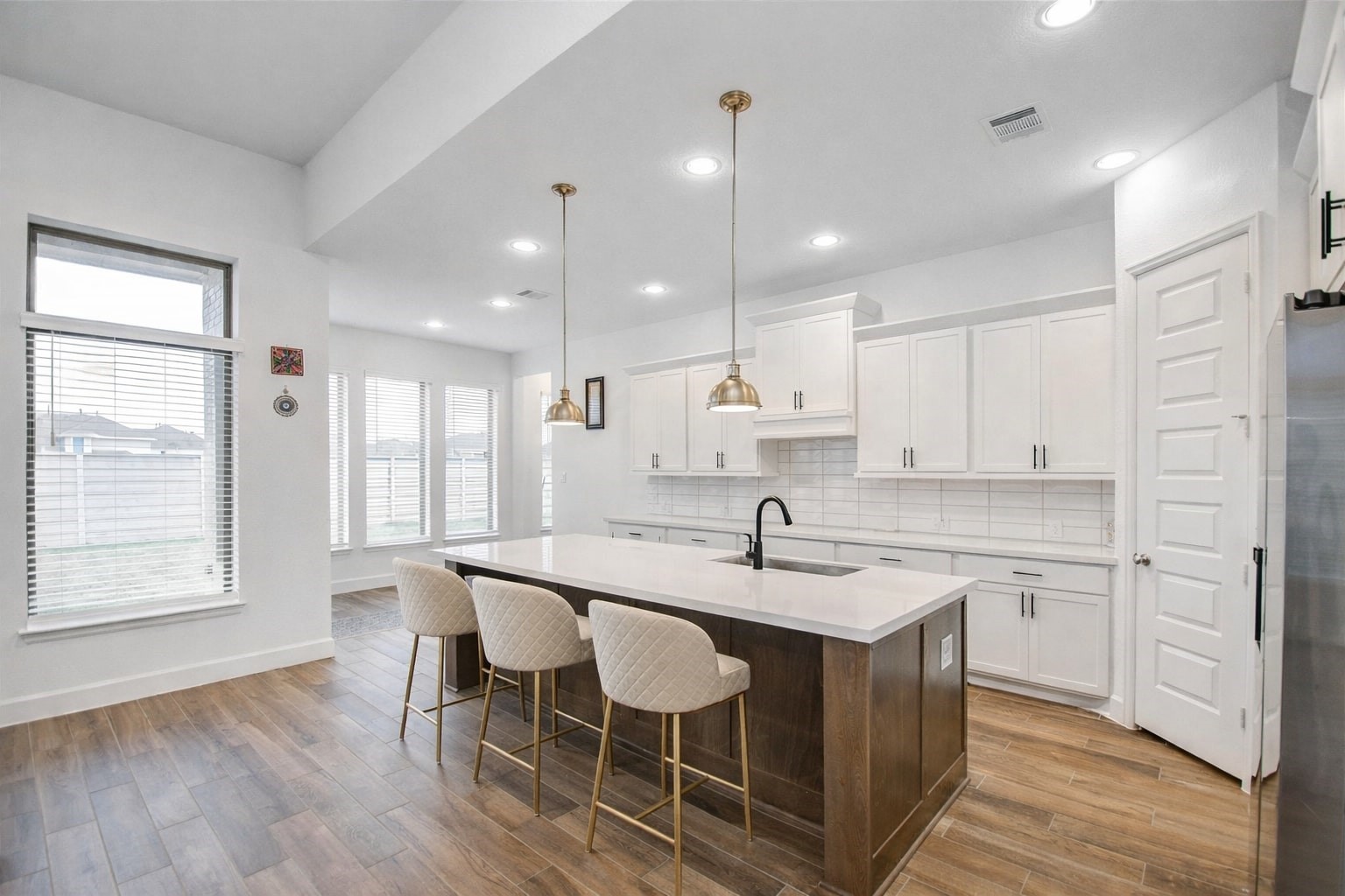 3011 Harbor Spring Way Manvel, TX 77578 - Photo 13 of 29 a kitchen with stainless steel appliances granite countertop a sink a stove and a wooden floors