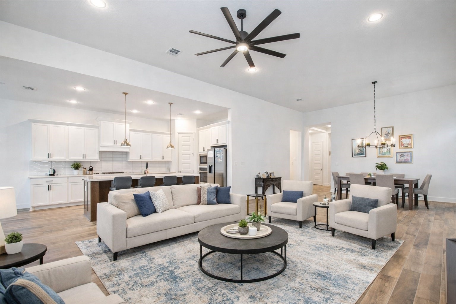 3011 Harbor Spring Way Manvel, TX 77578 - Photo 7 of 29 a living room with furniture kitchen view and a chandelier