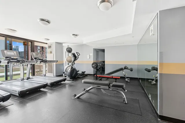 a room with gym equipment and a table