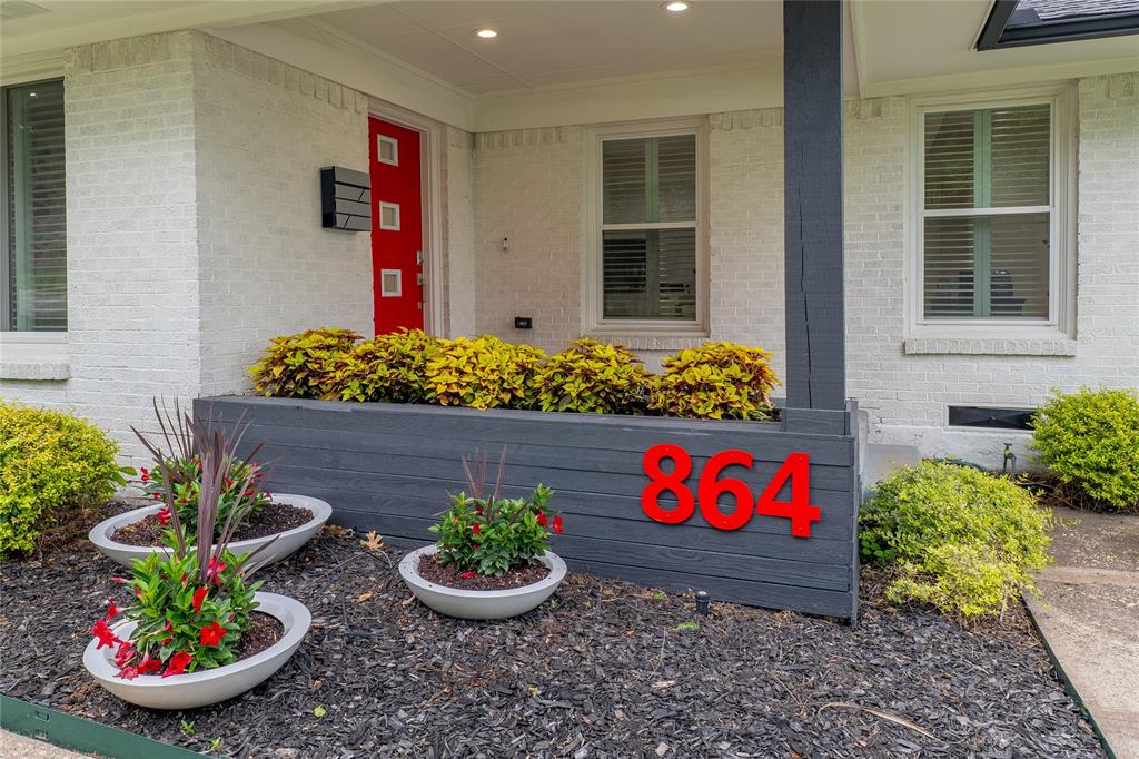 864 Peavy Road Dallas, TX 75218 - Photo 3 of 21 Modern exterior featuring white brick siding and a vibrant red entry door