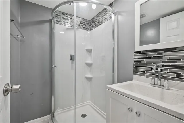 a bathroom with a sink a mirror and shower