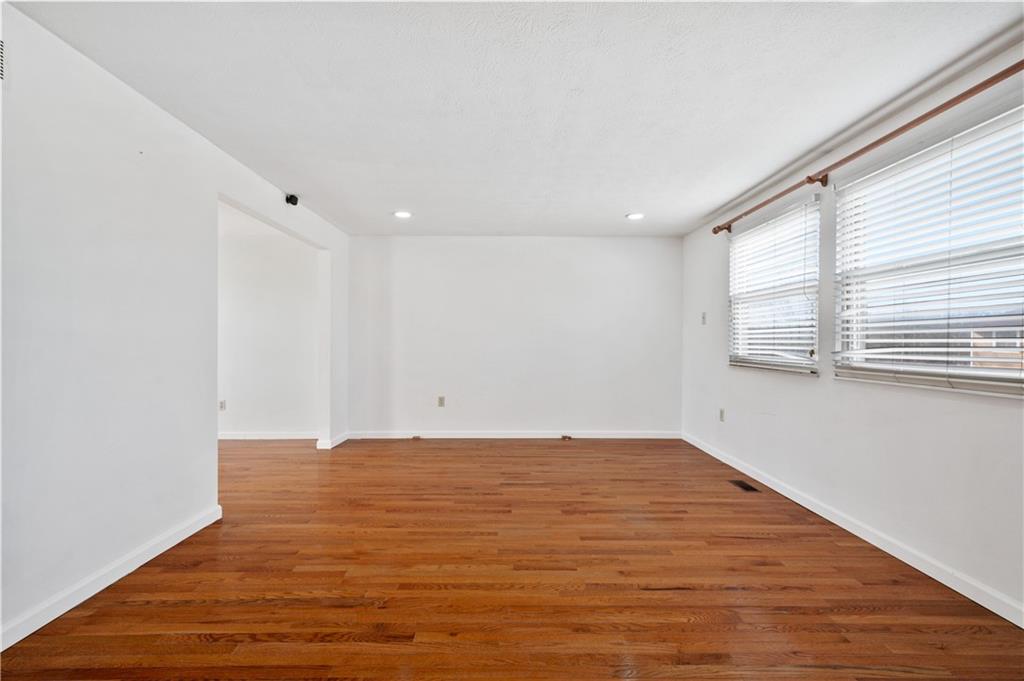 2203 Open Meadow Circle Bridgeville, PA 15017 - Photo 3 of 29 a view of an empty room with wooden floor and a window