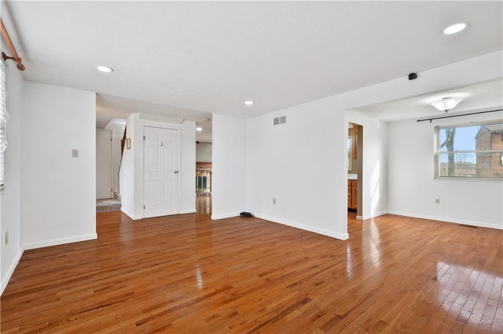 2203 Open Meadow Circle Bridgeville, PA 15017 - Photo 4 of 29 a view of an empty room with wooden floor and a window