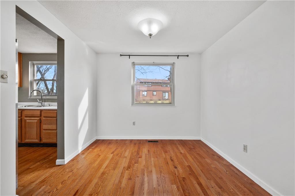 2203 Open Meadow Circle Bridgeville, PA 15017 - Photo 6 of 29 an empty room with wooden floor closet and windows