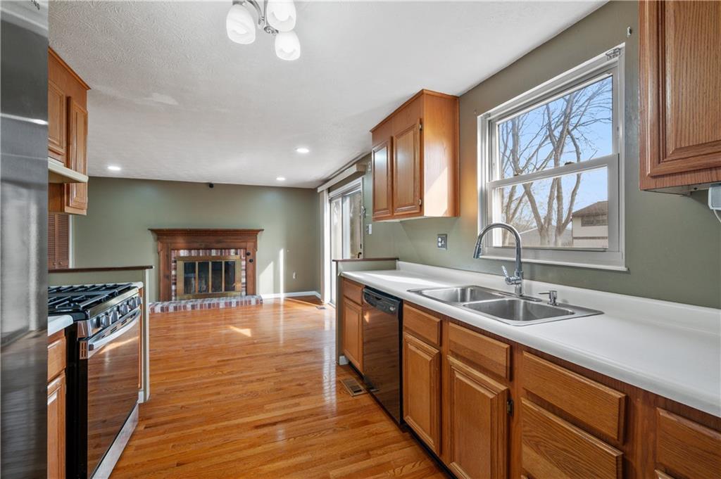 2203 Open Meadow Circle Bridgeville, PA 15017 - Photo 8 of 29 a kitchen with stainless steel appliances granite countertop a stove a sink and a microwave