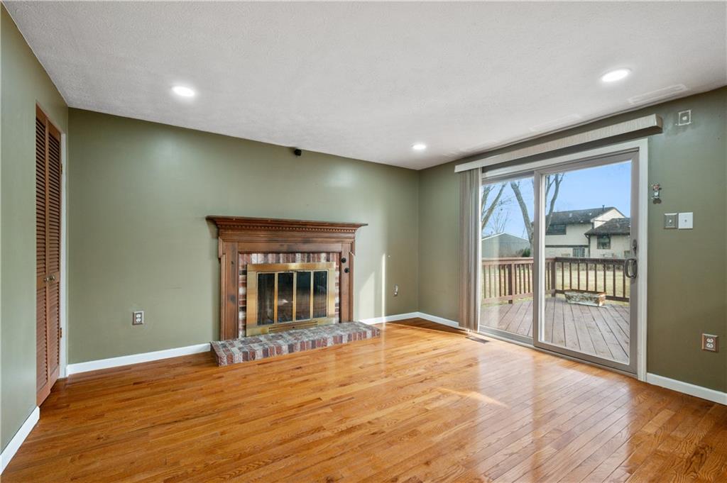 2203 Open Meadow Circle Bridgeville, PA 15017 - Photo 10 of 29 a view of an empty room with wooden floor and a window