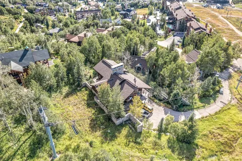 an aerial view of a residential houses with yard