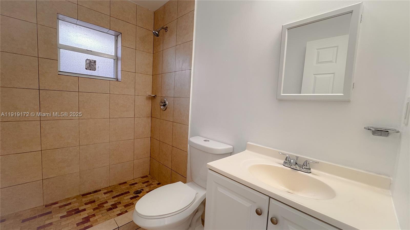 1835 Northwest 94th Street Miami, FL 33147 - Photo 14 of 22 a bathroom with a sink a toilet and shower