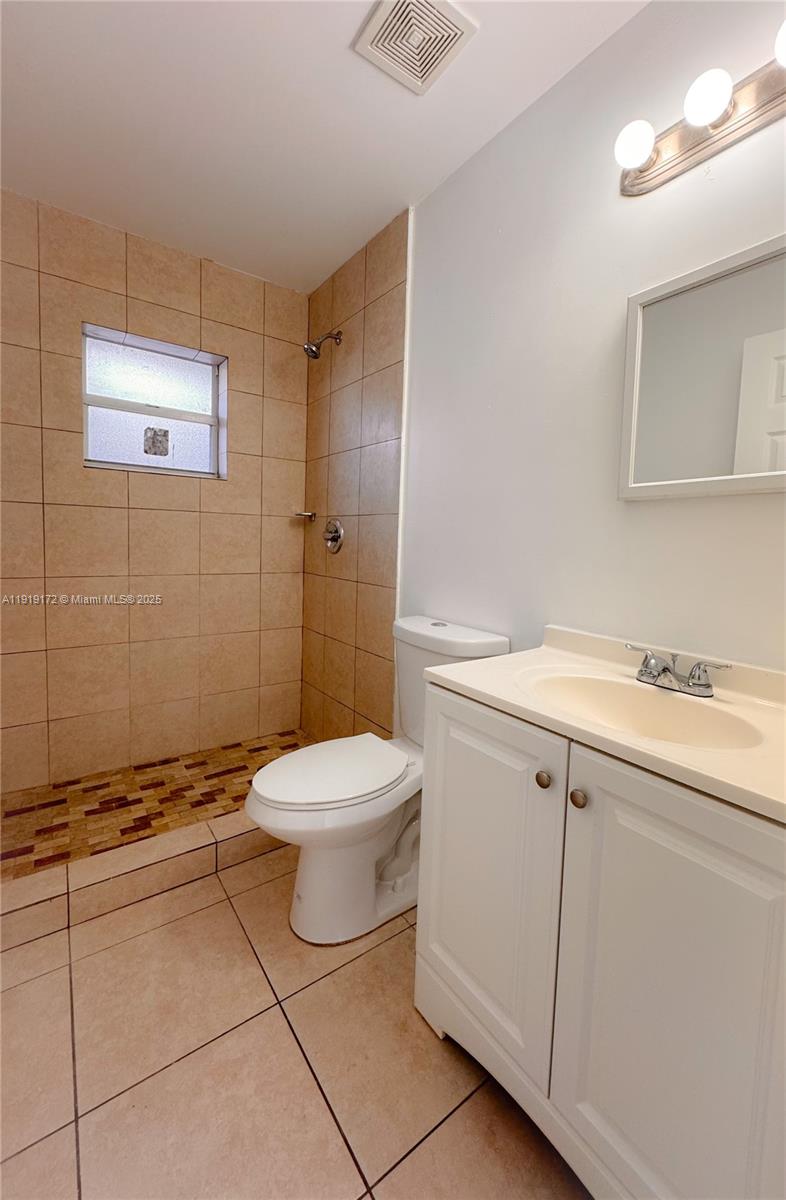 1835 Northwest 94th Street Miami, FL 33147 - Photo 15 of 22 a bathroom with a toilet sink and mirror