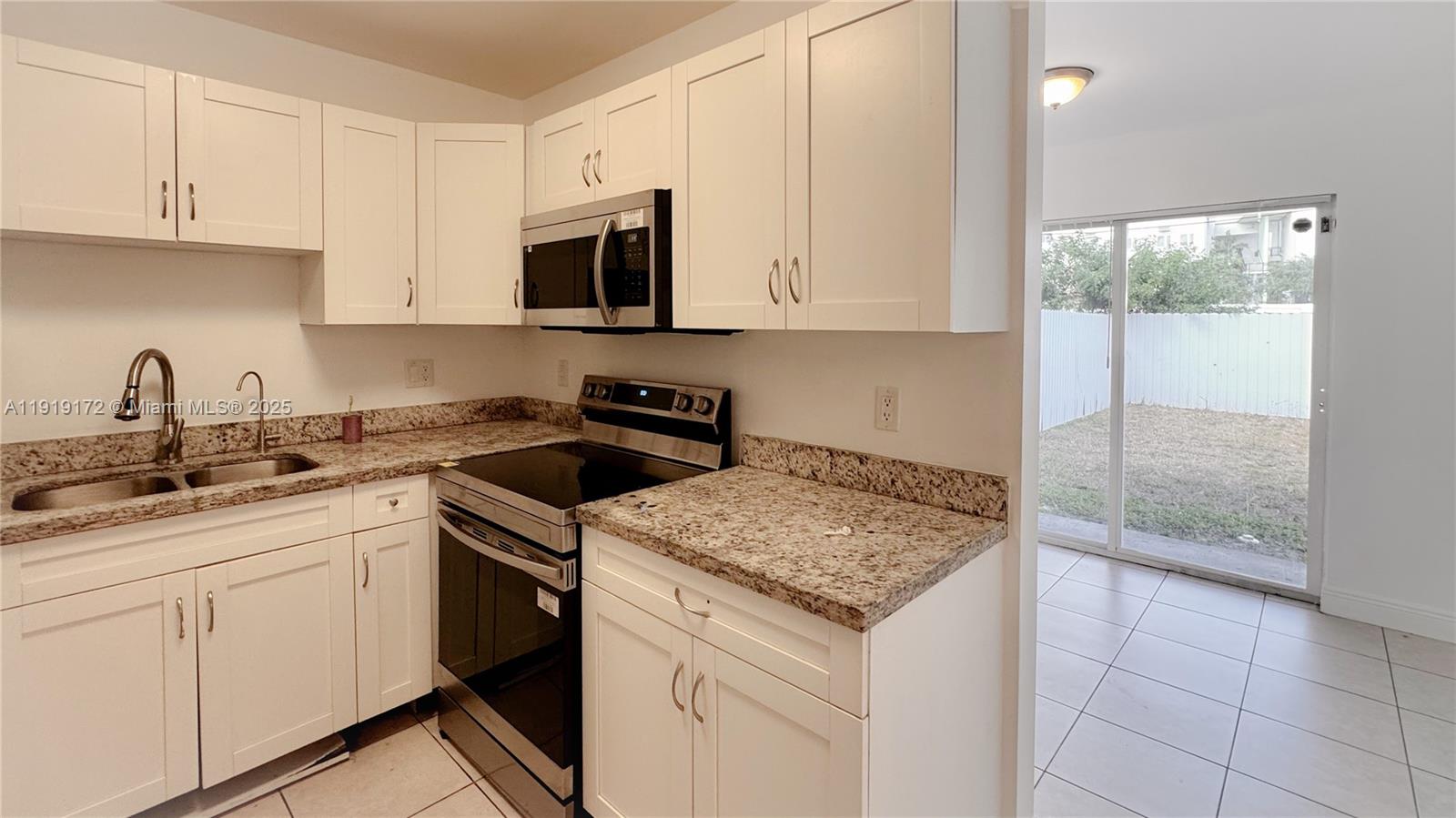 1835 Northwest 94th Street Miami, FL 33147 - Photo 6 of 22 a kitchen with a sink stove and cabinets