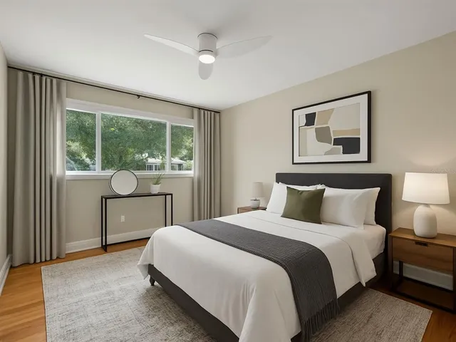 a bedroom with a large bed and a window