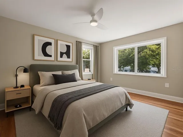 a bedroom with a bed and a large window