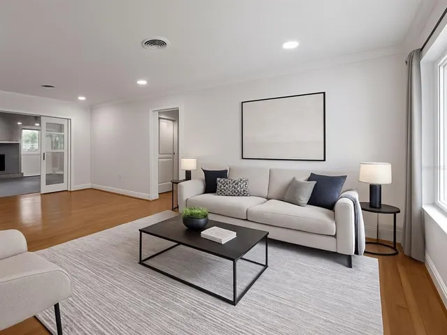 a living room with furniture and wooden floor