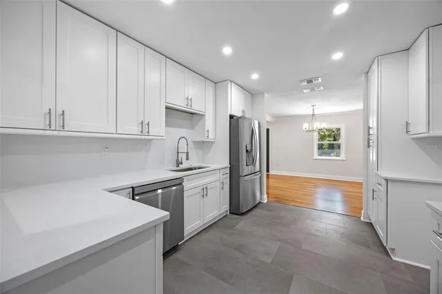 a kitchen with stainless steel appliances a refrigerator sink and cabinets