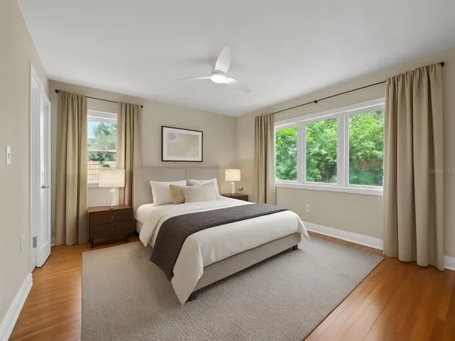 a bed room with a bed and a large window