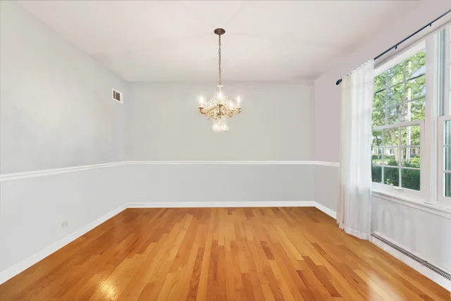 a view of a room with wooden floor and window