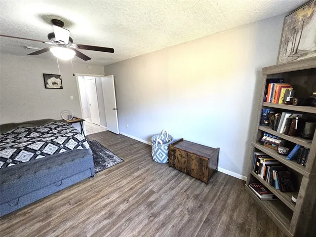 a bedroom with a bed and a book shelf