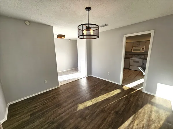 a view of a room with wooden floor cabinets and a ceiling fan