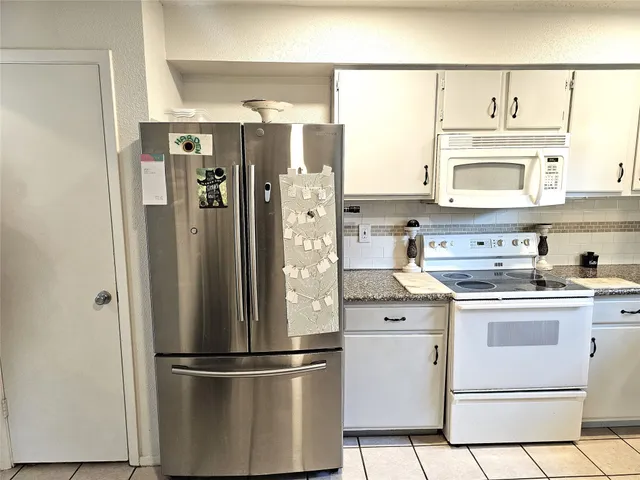 a kitchen with stainless steel appliances a refrigerator sink and cabinets