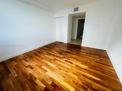 a view of a room with wooden floor and staircase