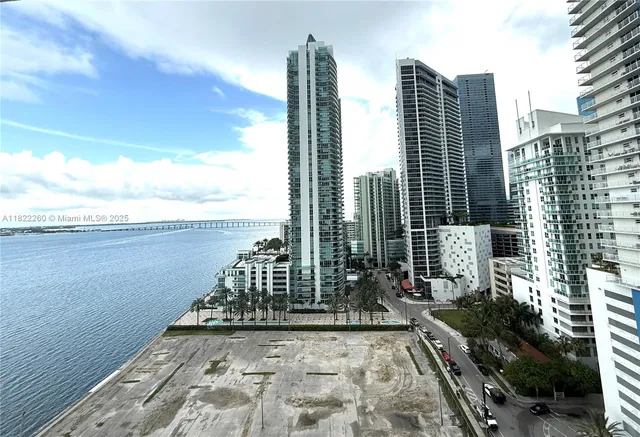 a view of balcony with wooden floor and lake view