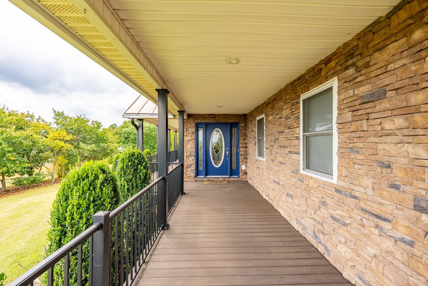 1704 Dearing Ford Road Altavista, VA 24517 - Photo 54 of 82 a view of a porch with wooden floor and stairs