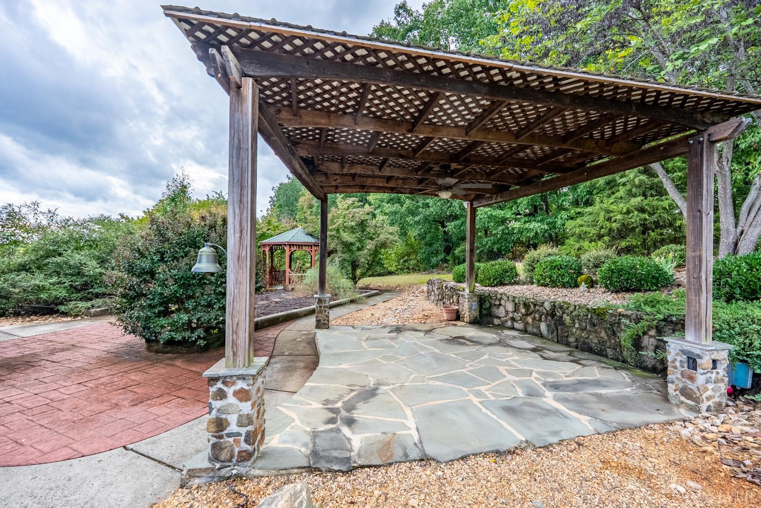 1704 Dearing Ford Road Altavista, VA 24517 - Photo 61 of 82 a view of a patio with table and chairs under an umbrella with a large tree