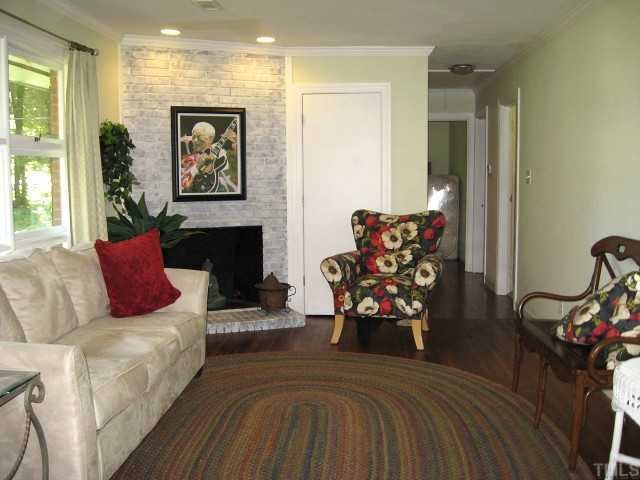 841 Cranbrook Road Raleigh, NC 27609 - Photo 3 of 10 Great living room with large window, brick gas fireplace, & hardwoods