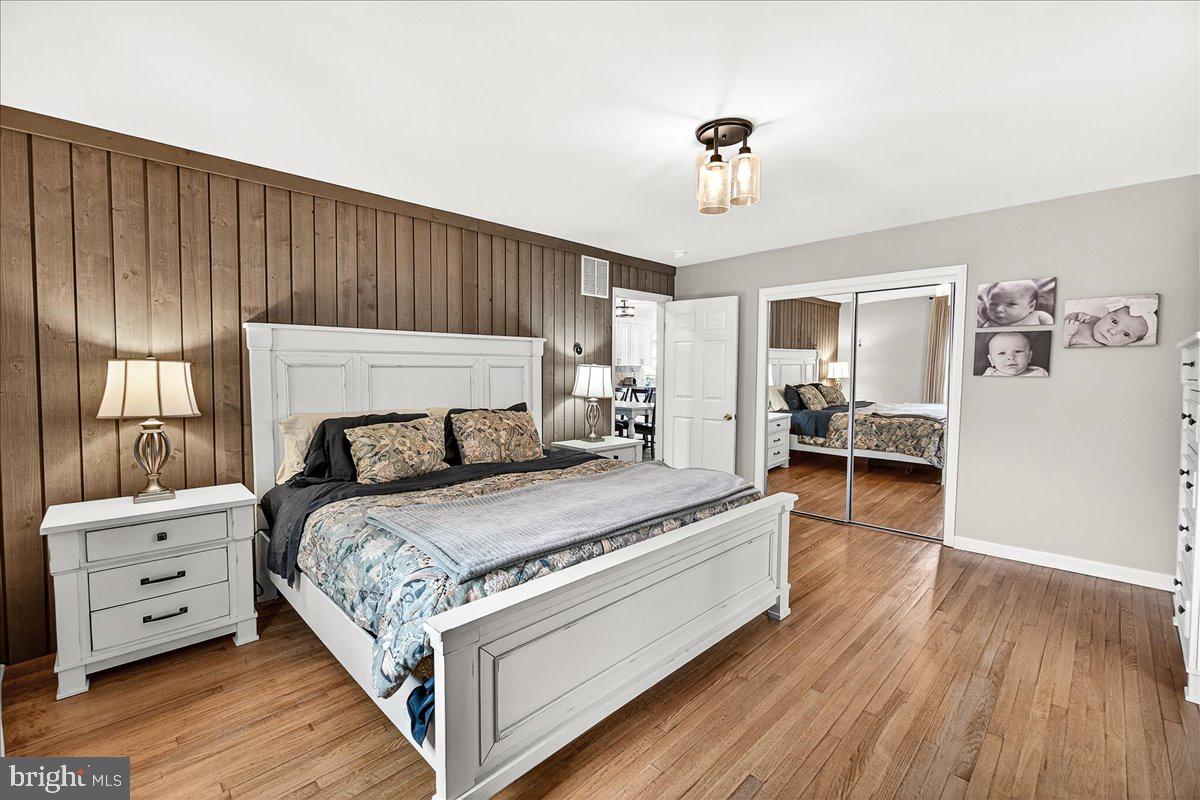 7201 Mountain Church Road Middletown, MD 21769 - Photo 21 of 37 a spacious bedroom with a bed and a chandelier