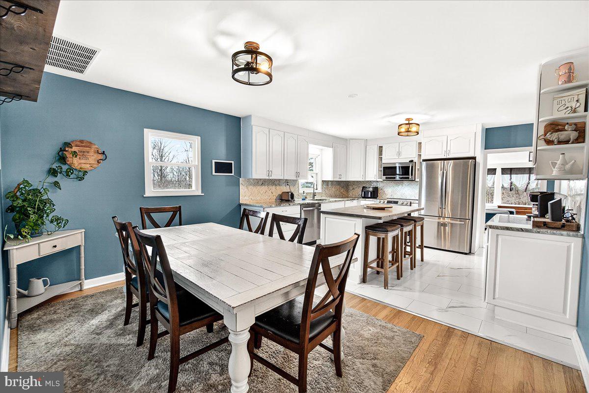 7201 Mountain Church Road Middletown, MD 21769 - Photo 10 of 37 a view of a dining room with furniture and a kitchen