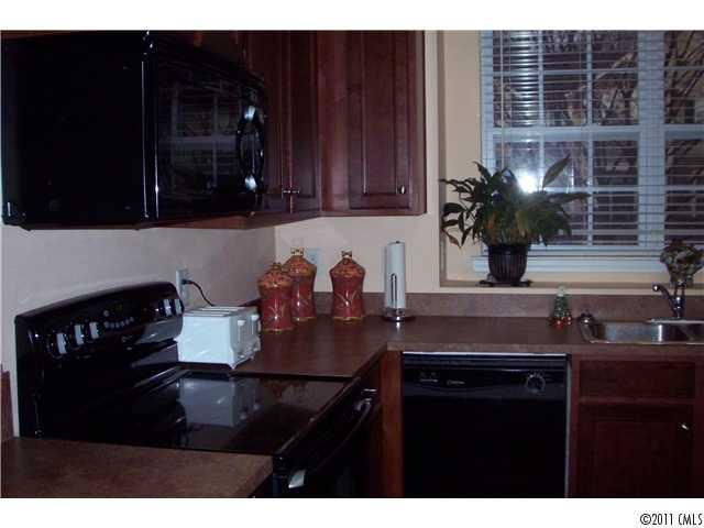 958 Copperstone Lane, Unit 162 Fort Mill, SC 29708 - Photo 7 of 14 a kitchen with a sink cabinets and stove