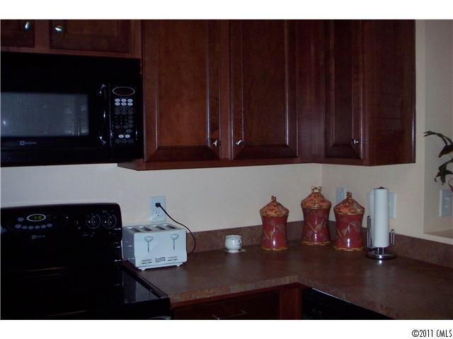 958 Copperstone Lane, Unit 162 Fort Mill, SC 29708 - Photo 8 of 14 a kitchen with wooden cabinets