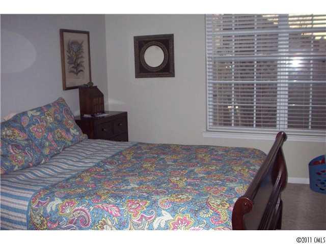 958 Copperstone Lane, Unit 162 Fort Mill, SC 29708 - Photo 10 of 14 a bedroom with a bed and a desk