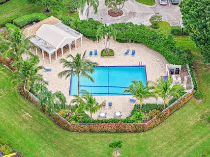 a front view of a house with a yard and potted plants