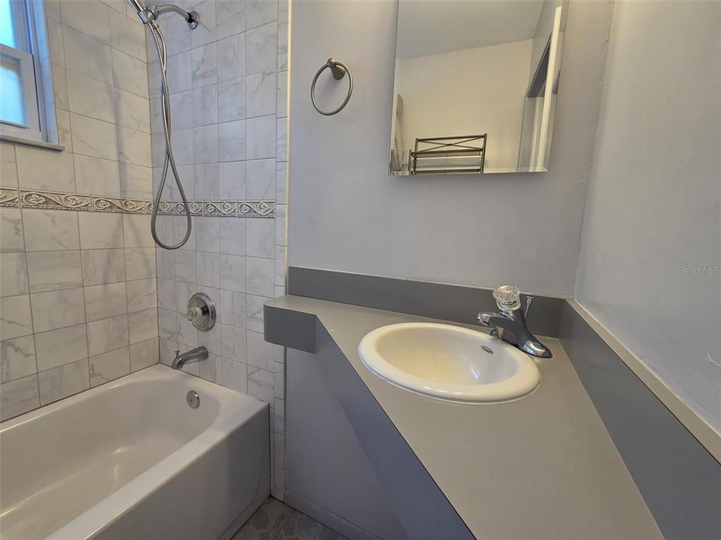 7216 James Street Port Richey, FL 34668 - Photo 18 of 28 a bathroom with a sink a bathtub and a shower
