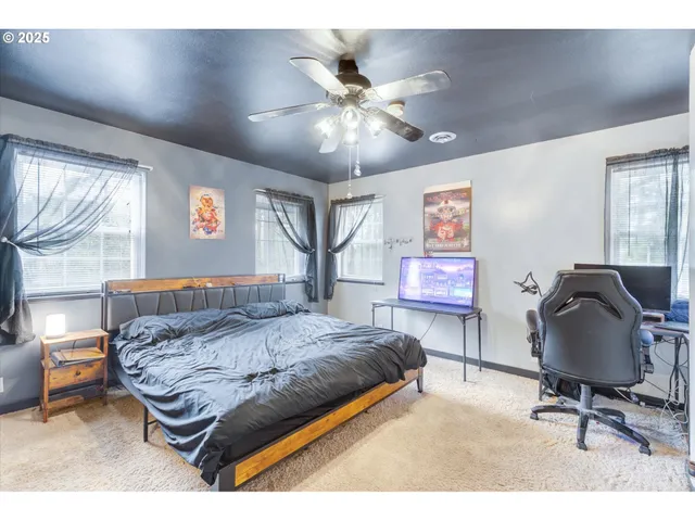 a bedroom with a bed window and furniture