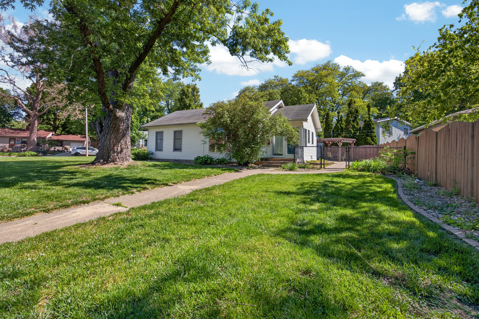 18 Mc Cormick Boulevard Normal, IL 61761 - Photo 1 of 25 a backyard of a house with garden and trees