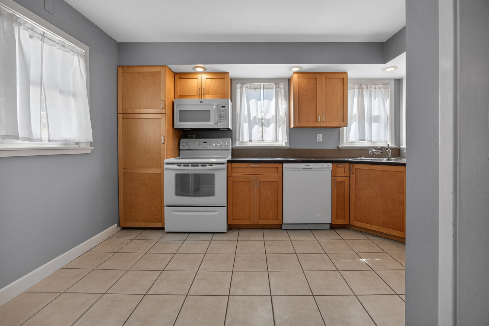 18 Mc Cormick Boulevard Normal, IL 61761 - Photo 7 of 25 a kitchen with stainless steel appliances granite countertop a stove a sink and a microwave