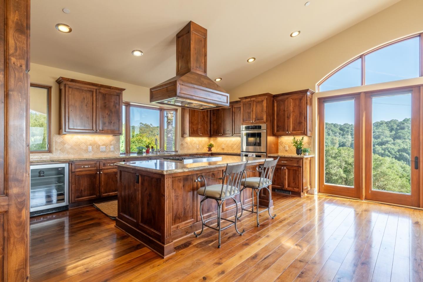 67 Tucker Road Watsonville, CA 95076 - Photo 12 of 32 a kitchen with stainless steel appliances granite countertop a stove top oven a sink dishwasher and wooden cabinets with wooden floor