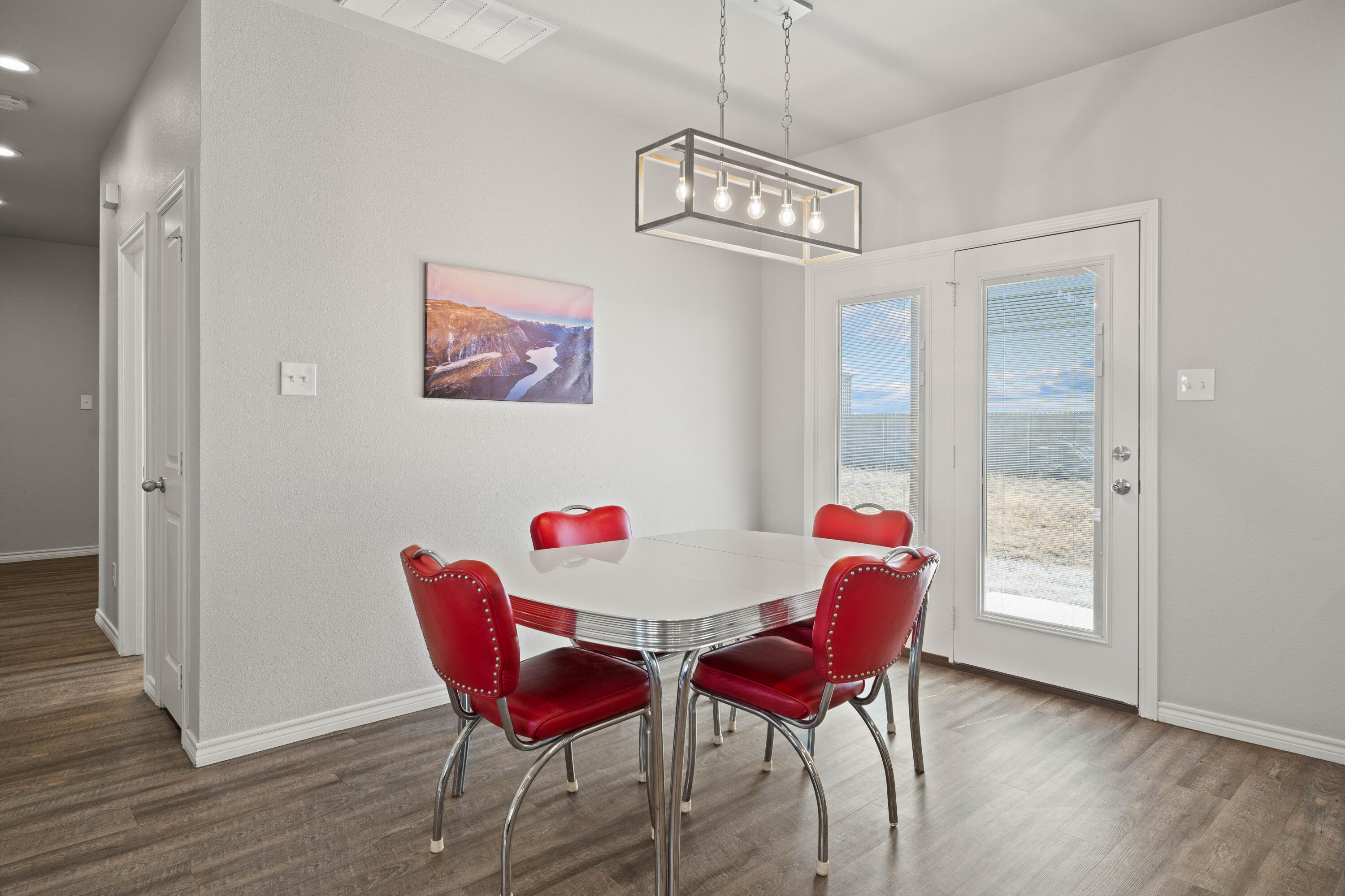 8907 County Road 6100 Shallowater, TX 79363 - Photo 11 of 24 a view of a dining room with furniture and wooden floor