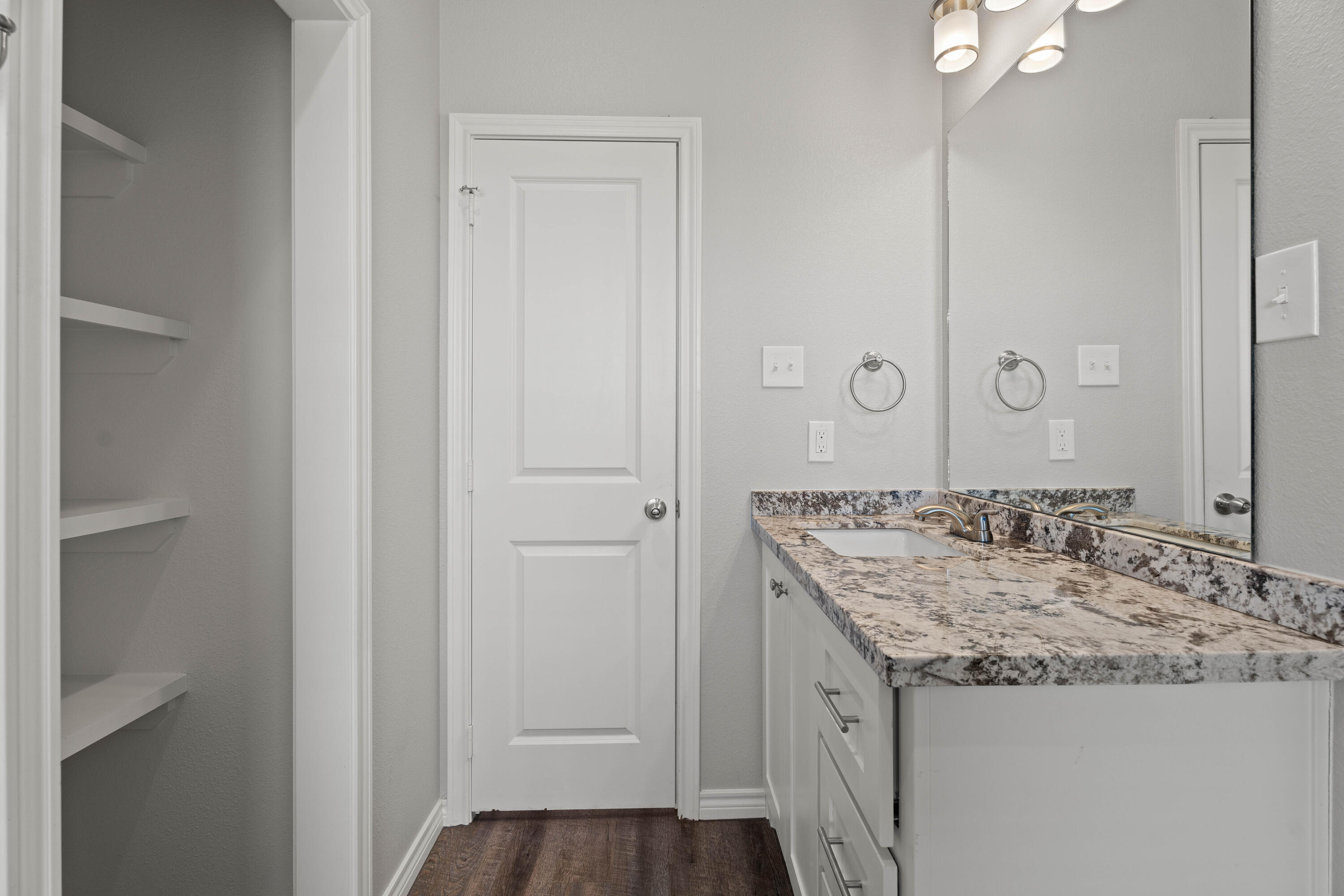8907 County Road 6100 Shallowater, TX 79363 - Photo 18 of 24 a bathroom with a granite countertop sink and a mirror