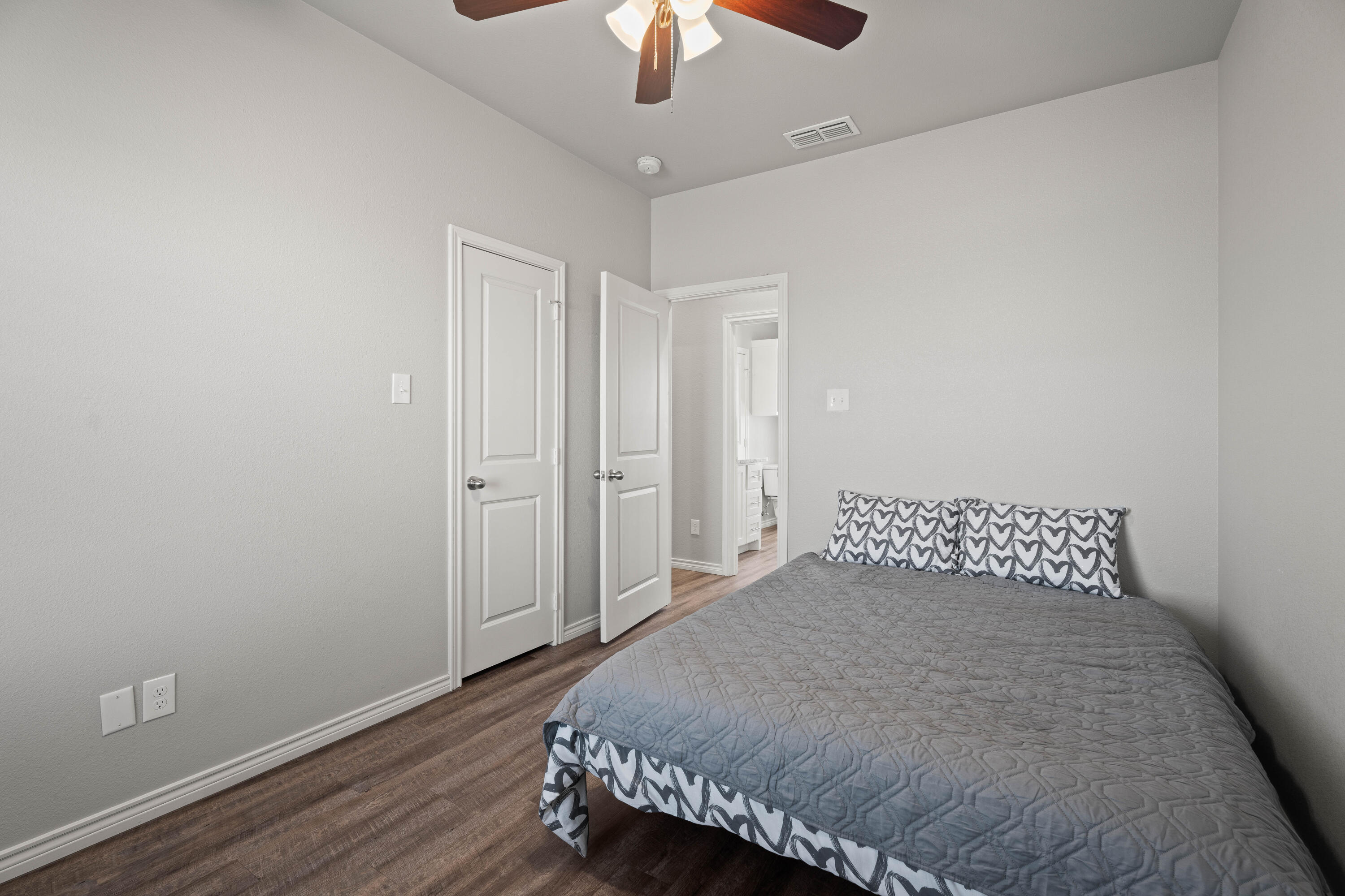 8907 County Road 6100 Shallowater, TX 79363 - Photo 20 of 24 a bedroom with a bed and a chandelier