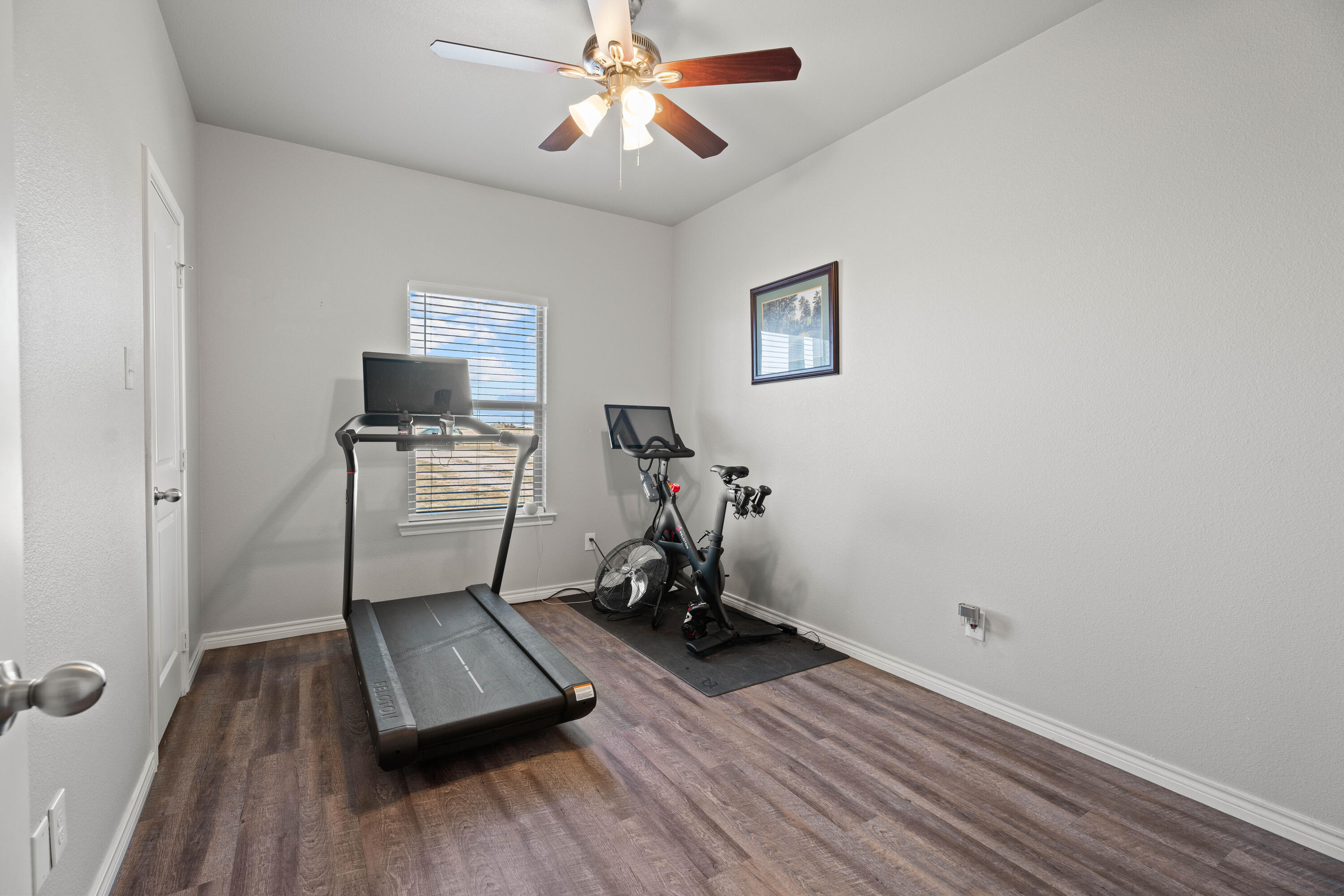 8907 County Road 6100 Shallowater, TX 79363 - Photo 21 of 24 a view of room with wooden floor and ceiling fan