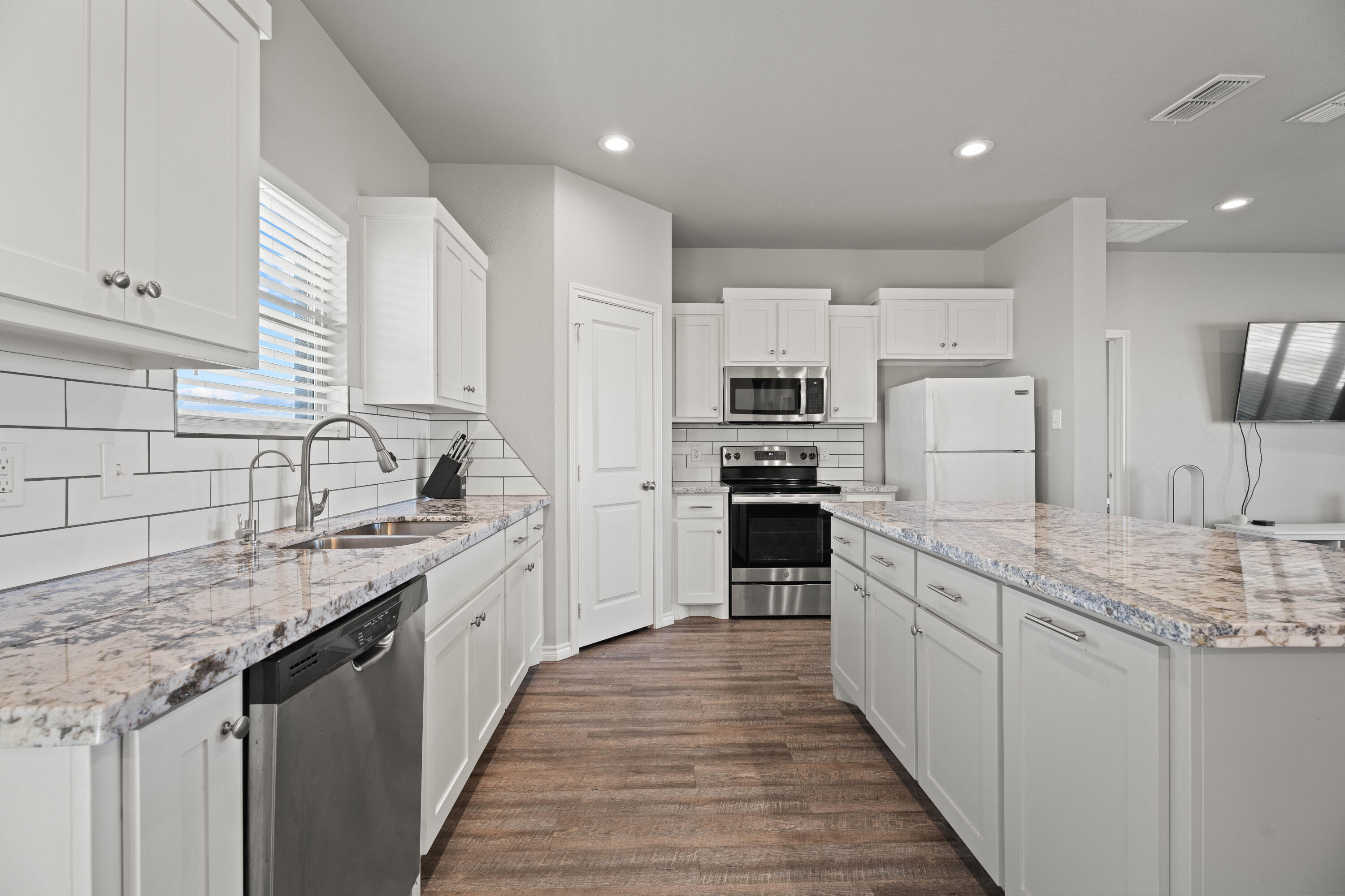 8907 County Road 6100 Shallowater, TX 79363 - Photo 7 of 24 a kitchen with stainless steel appliances granite countertop a sink stove refrigerator and cabinets