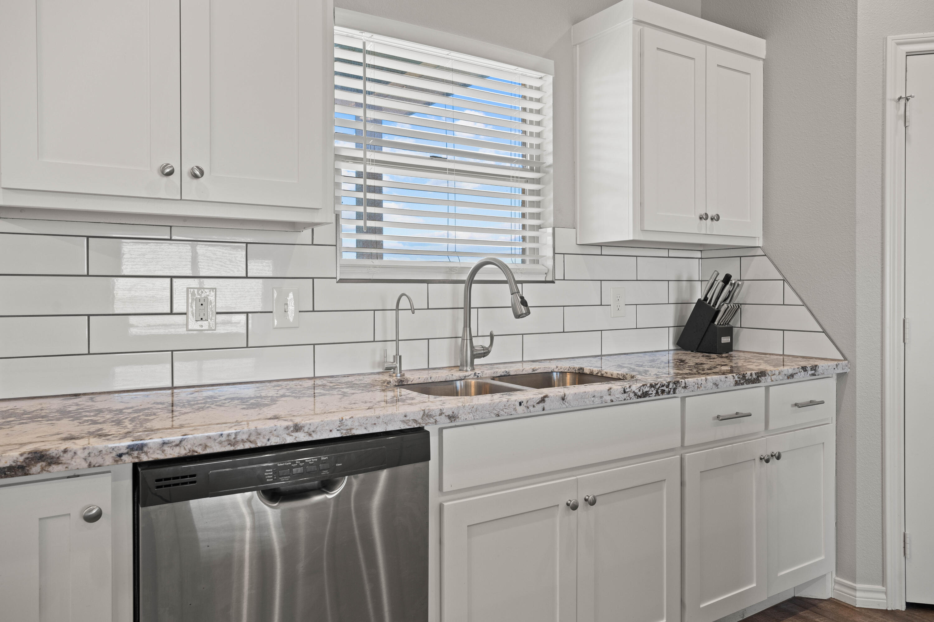 8907 County Road 6100 Shallowater, TX 79363 - Photo 8 of 24 a kitchen with stainless steel appliances granite countertop a sink stove and cabinets