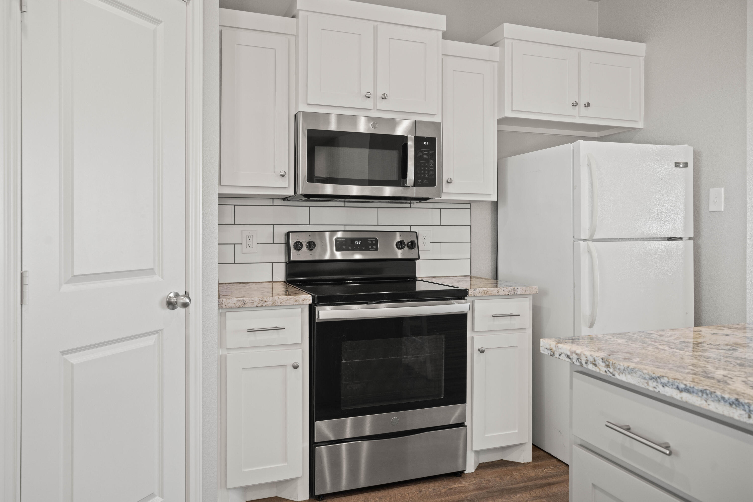 8907 County Road 6100 Shallowater, TX 79363 - Photo 9 of 24 a kitchen with a stove and a microwave