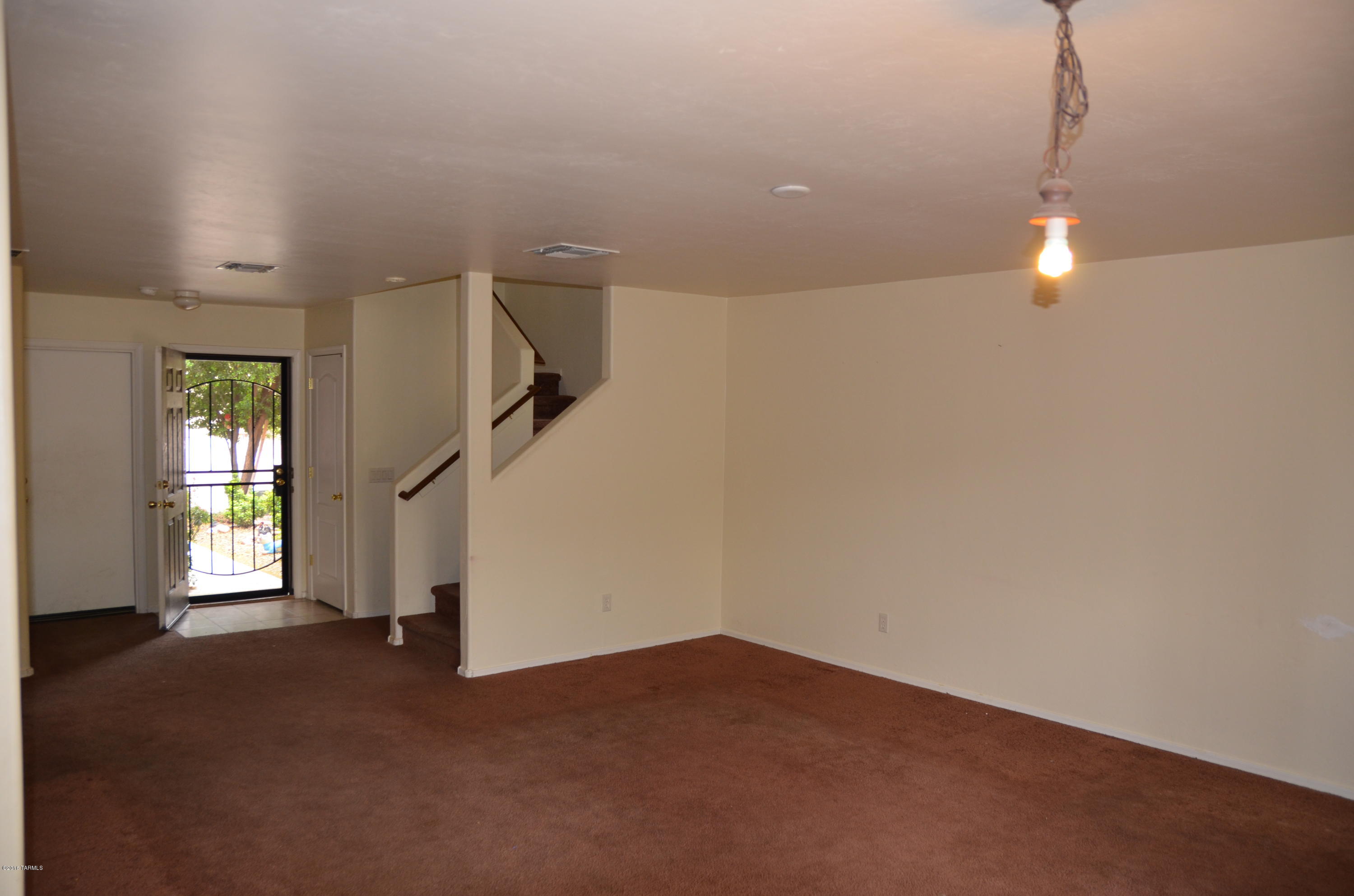 698 West Ash Ridge Drive Green Valley, AZ 85614 - Photo 9 of 19 a view of empty room with stairs and wooden floor