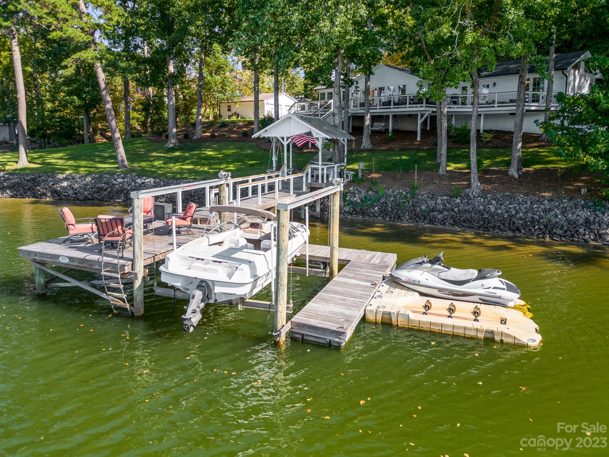 a view of a house with pool and chairs