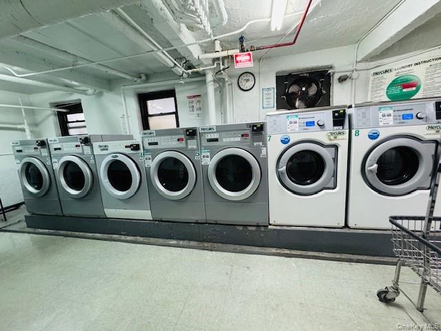 92-05 Whitney Avenue, Unit A27 Queens, NY 11373 - Photo 9 of 14 Laundry area with separate washer and dryer